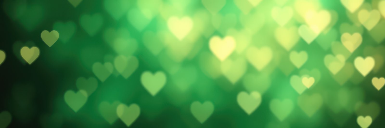 Sparkling heart shapes create a dreamy green background for romantic or festive occasions